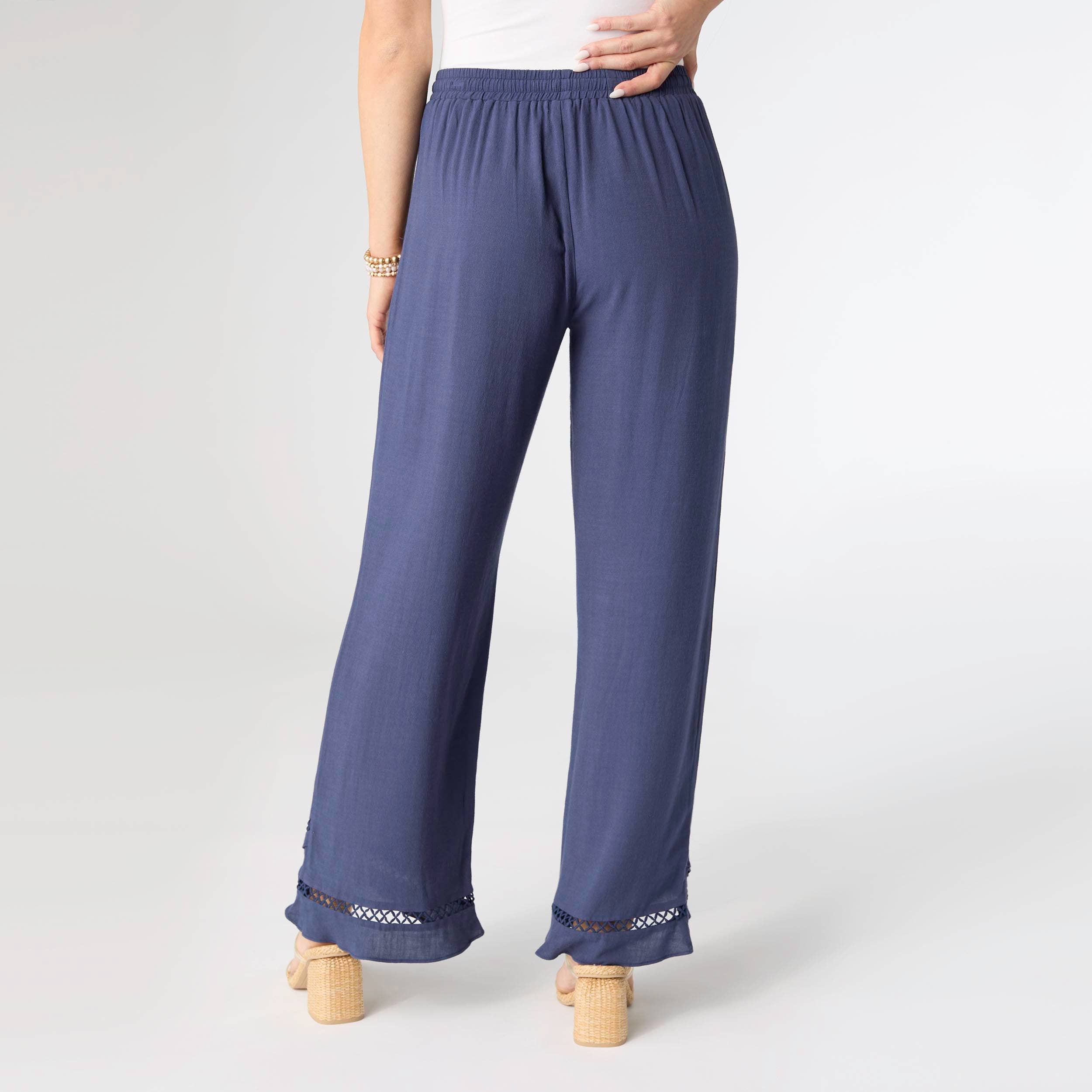 Navy blue pants with lace trim on a white background