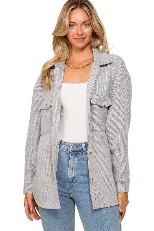 Woman wearing an open heather gray brushed waffle knit shacket with flap pockets over a white tank and jeans