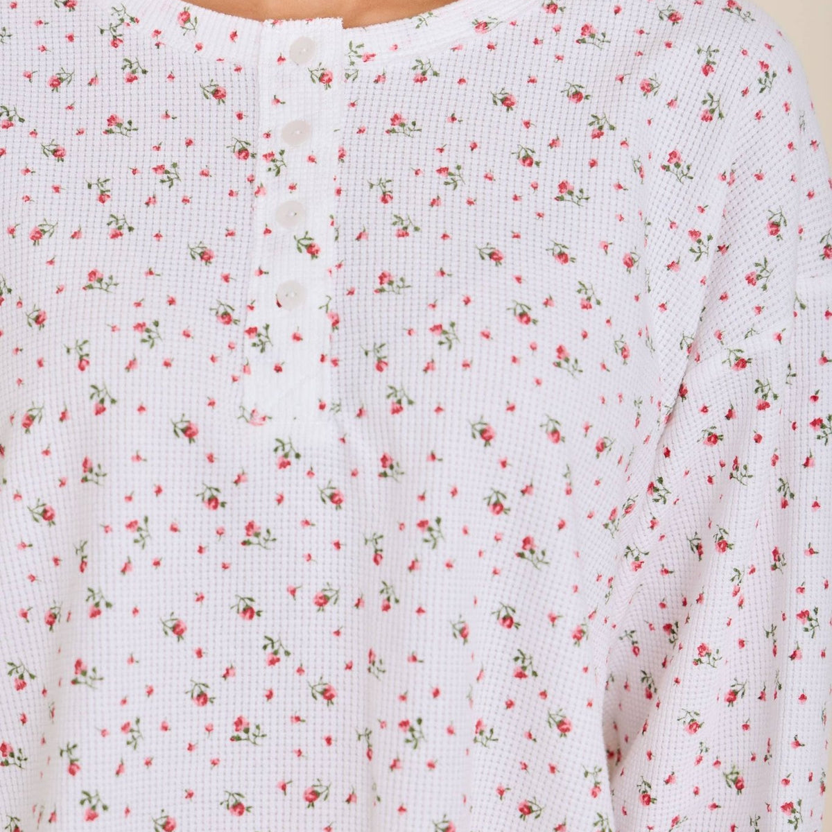 Close-up of the ditsy floral print and button-front placket on the waffle knit henley top