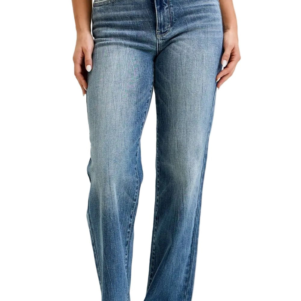 Person wearing blue jeans and a striped shirt on a plain background