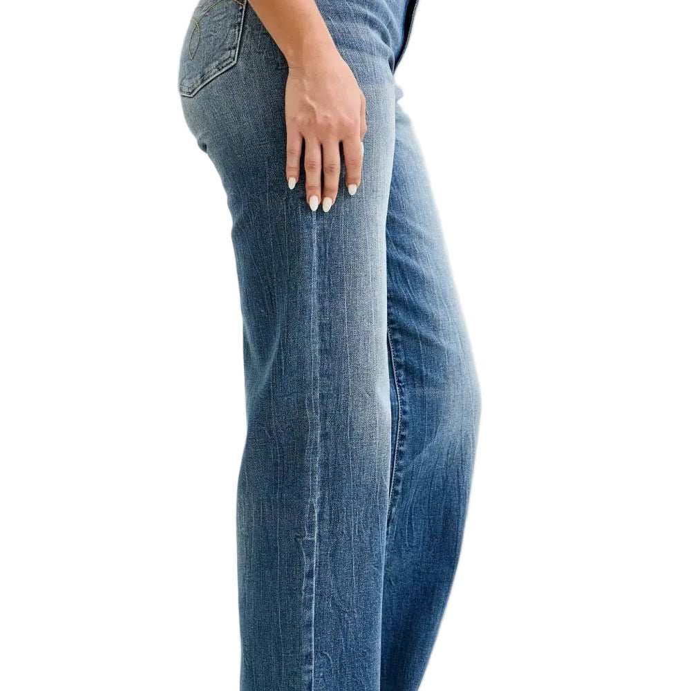 Person wearing blue jeans on a plain background