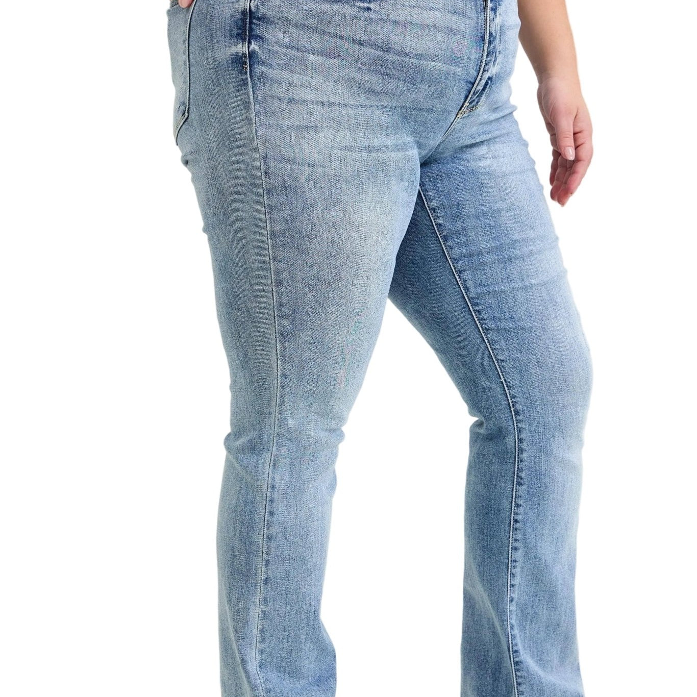 Person wearing blue jeans and a red top on a plain background
