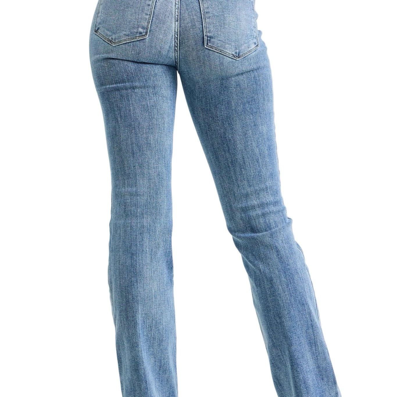 Person wearing blue jeans on a plain background