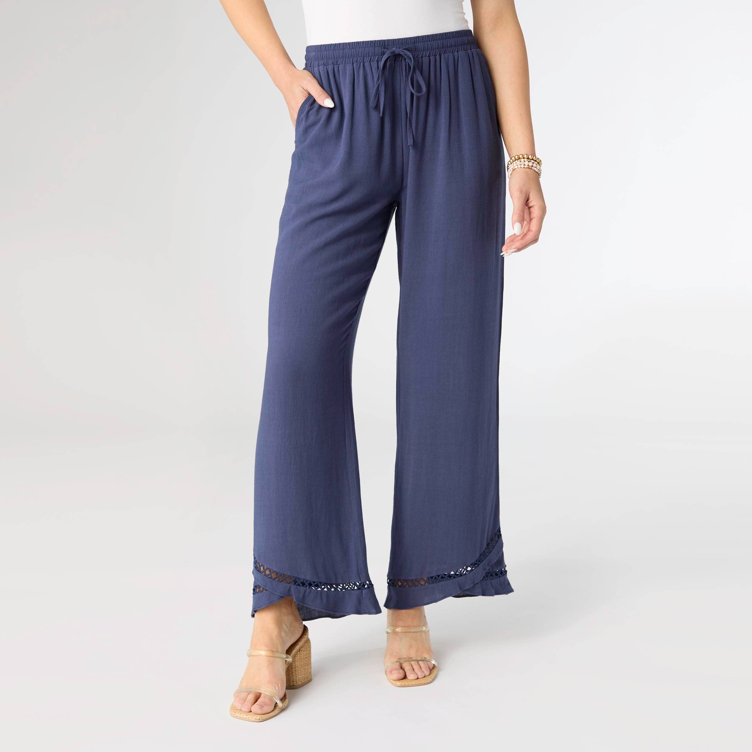 Navy blue pants with beaded hem on a white background