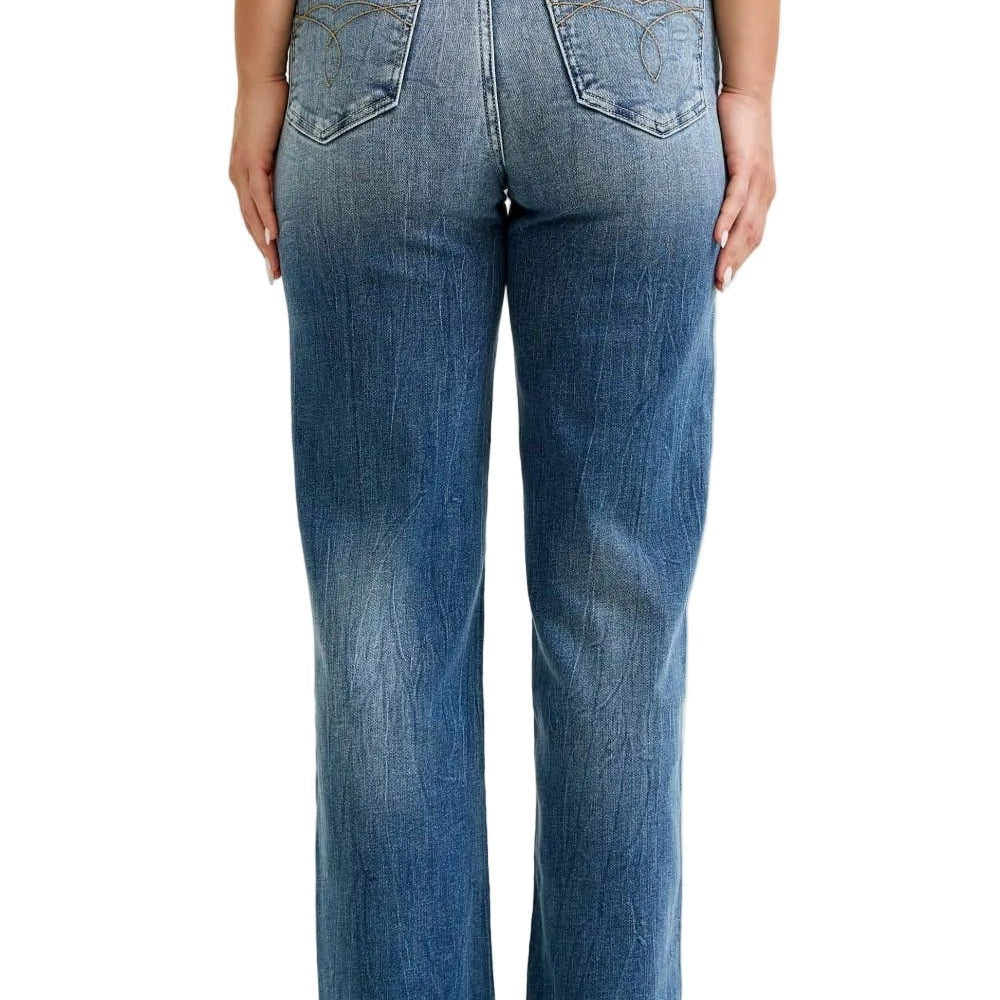 Person wearing blue jeans on a plain background