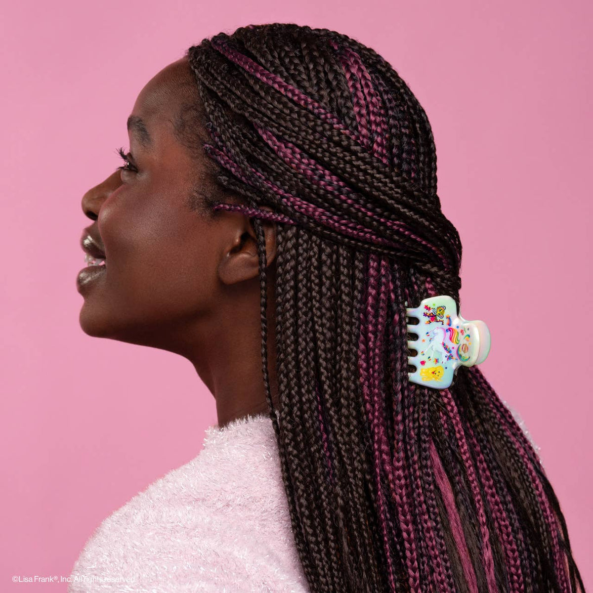 Woman wearing the Lisa Frank x Kitsch Cloud Clip in long braids, side view