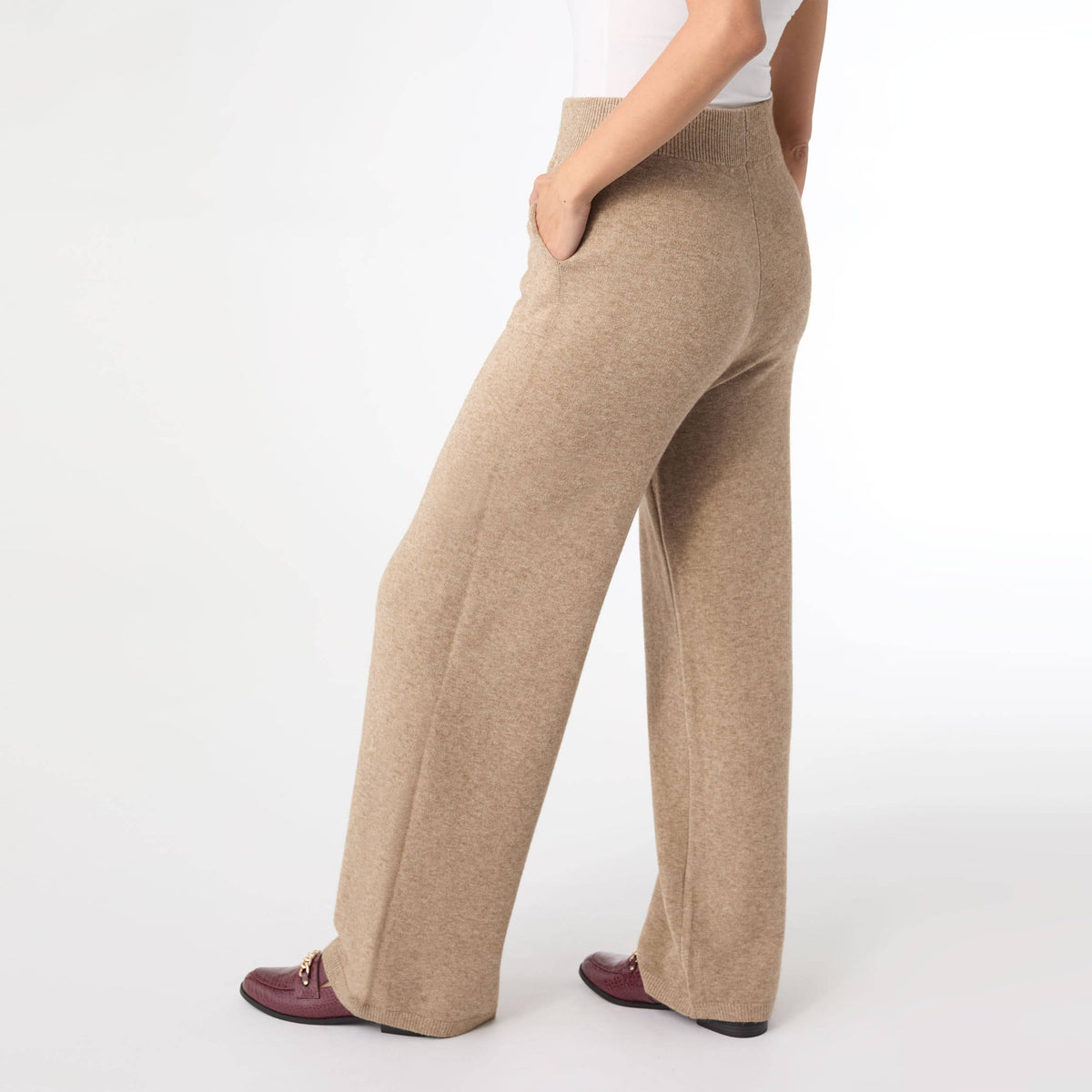 Side view of beige knit wide leg pull on sweater pants showing the relaxed wide leg