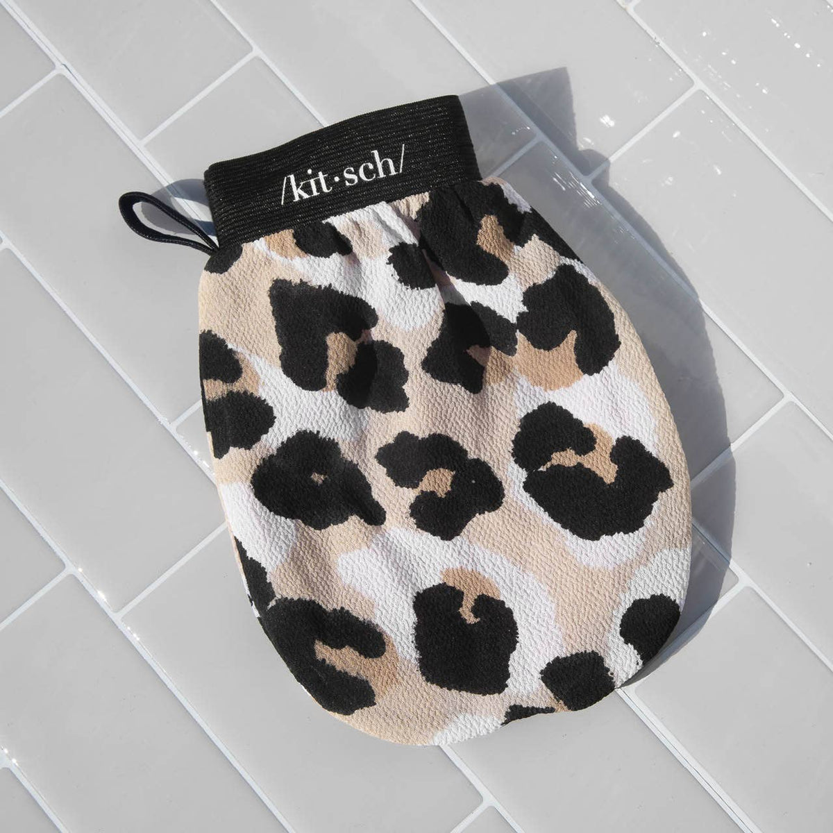 Kitsch leopard exfoliating glove on a gray background
