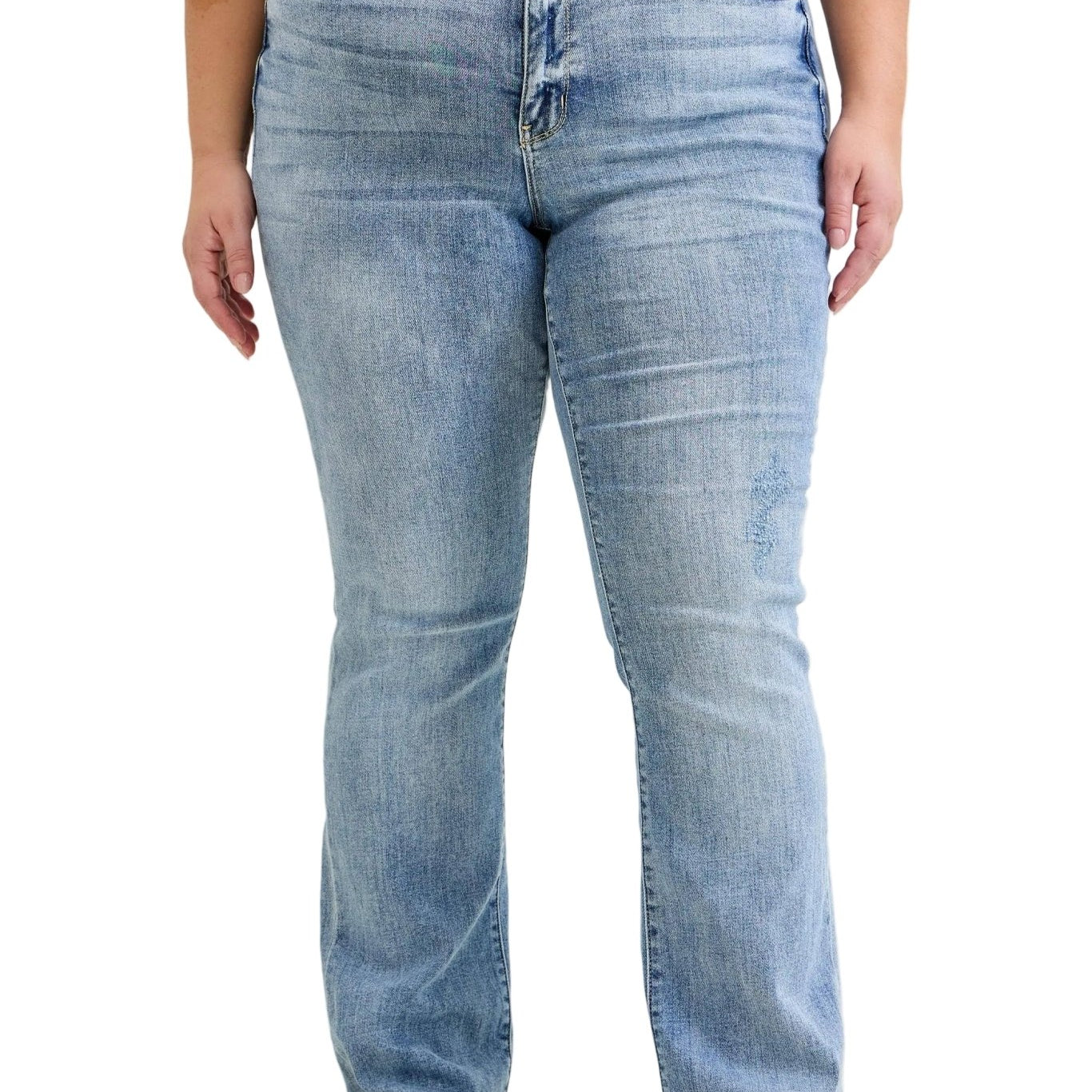 Person wearing light blue jeans and a red top on a plain background