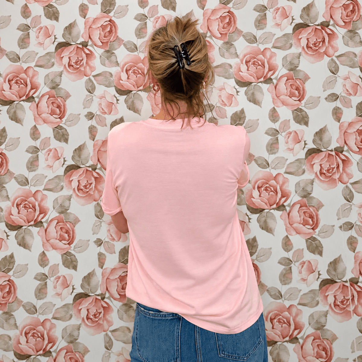 Back view of pink floral pumpkin graphic tee showing the plain back and relaxed short sleeve fit