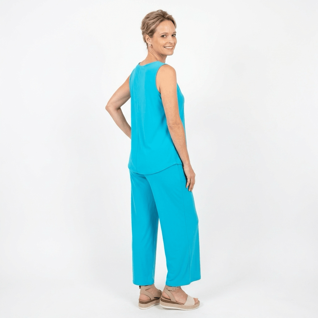Woman wearing a bright blue outfit on a white background