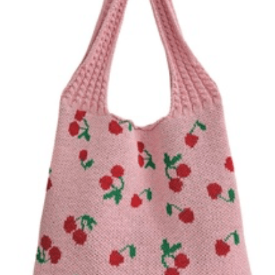 Pink knitted bag with cherry pattern on a white background