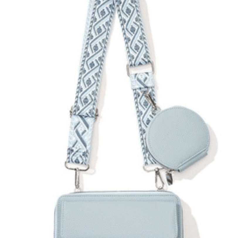 Light blue vegan leather crossbody bag with silver hardware, hanging view
