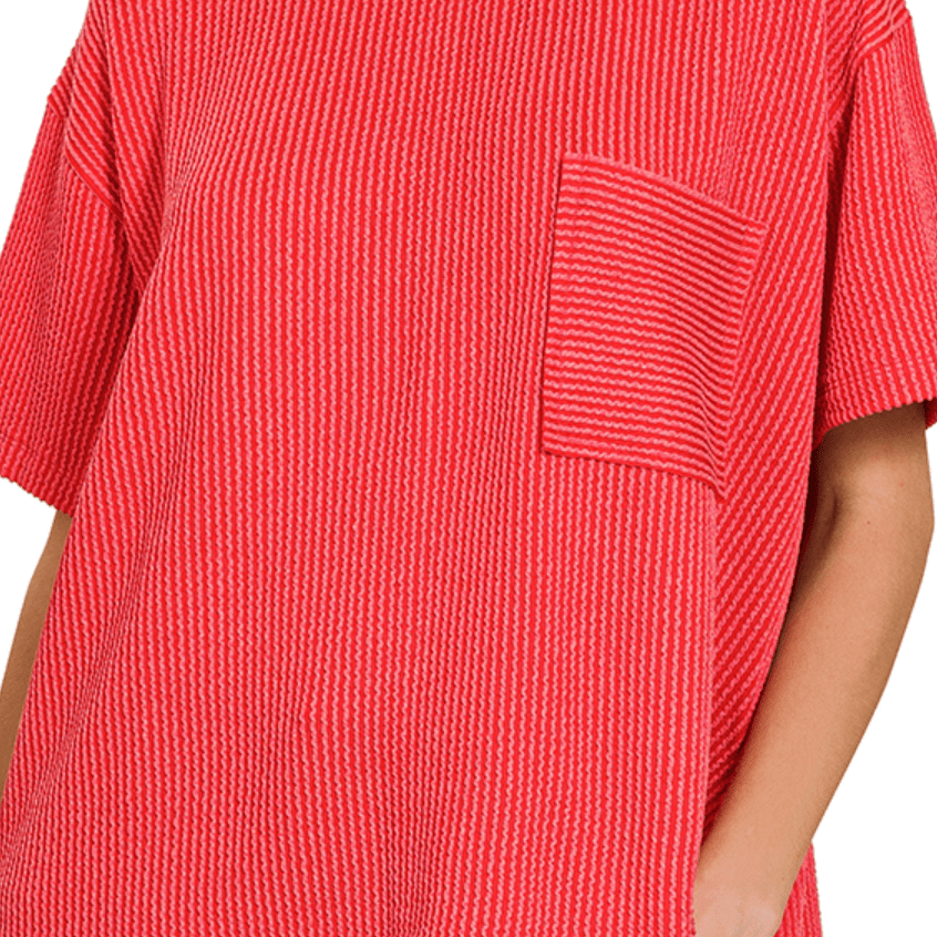 Red textured shirt with a pocket on a white background