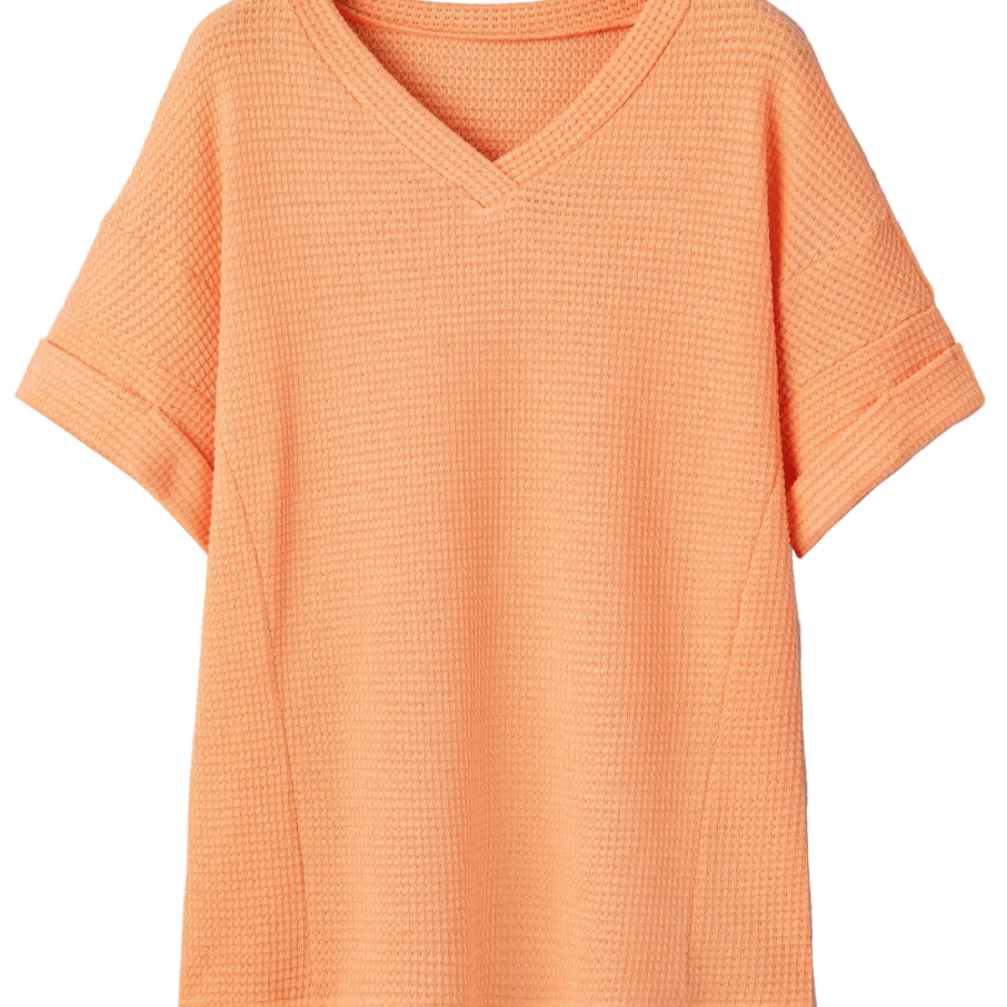 Orange textured t-shirt on a hanger against a light gray background