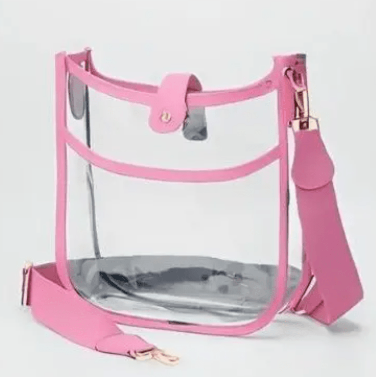 Pink outlined see thru purse against a gray background.