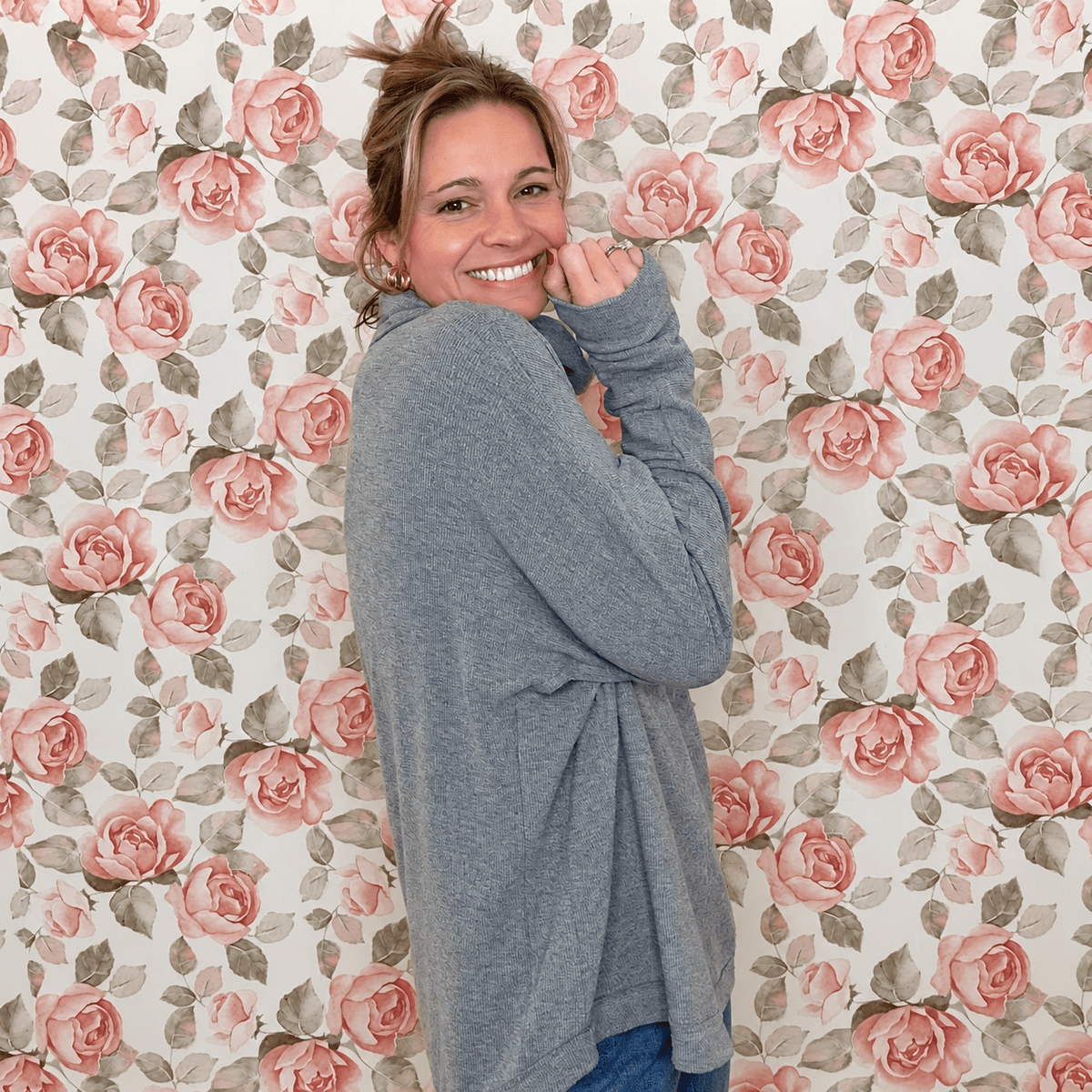 Side view of the heather gray dolman tunic top showing the relaxed fit and rounded hem