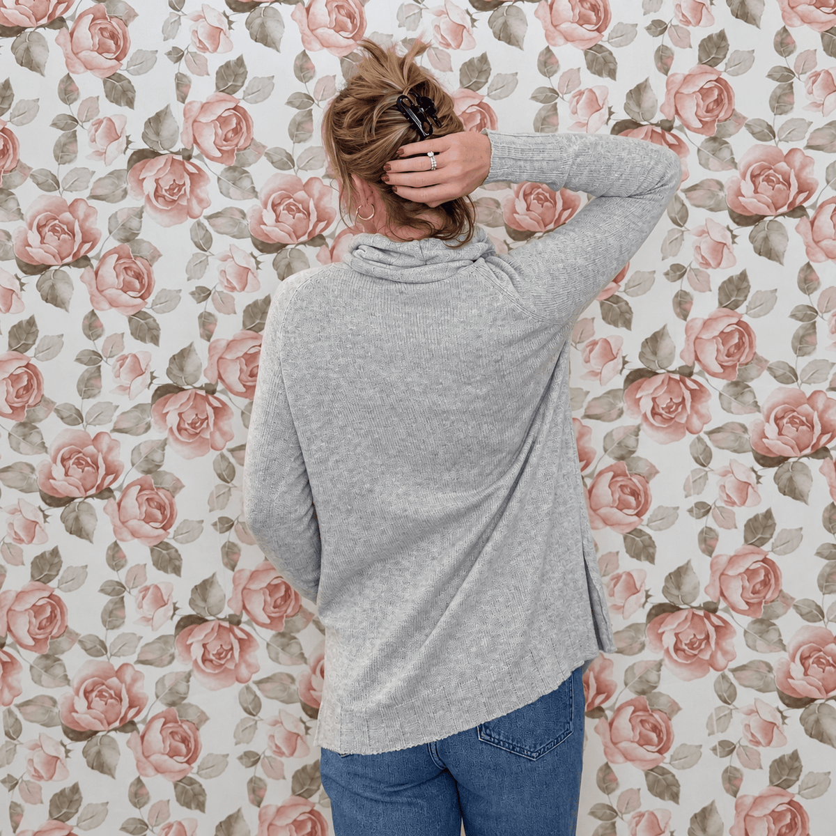 Back view of the heather grey cowl neck sweater showing the relaxed fit and tunic length