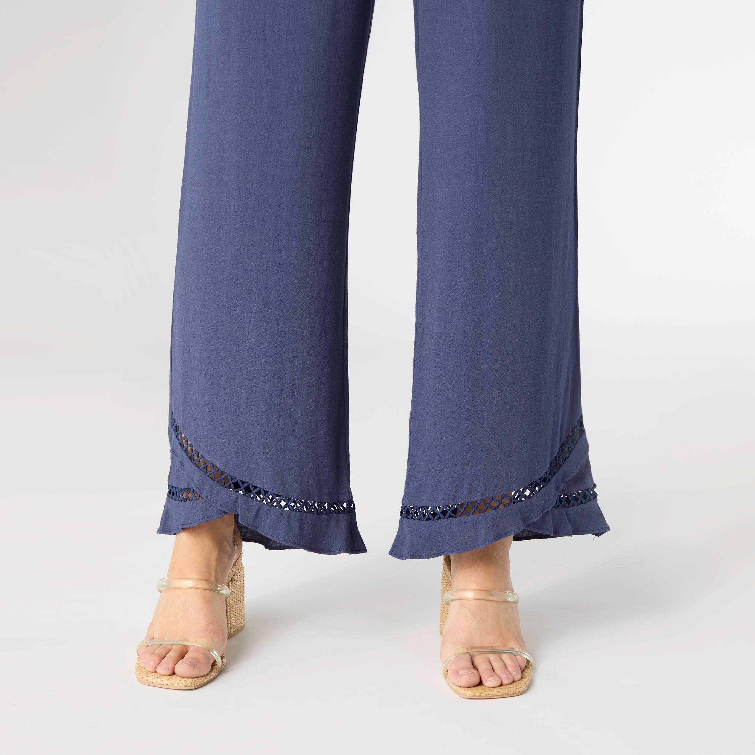 Navy blue pants with lace trim on a white background