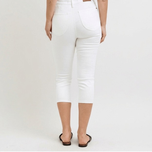 White jeans worn by a person on a white background
