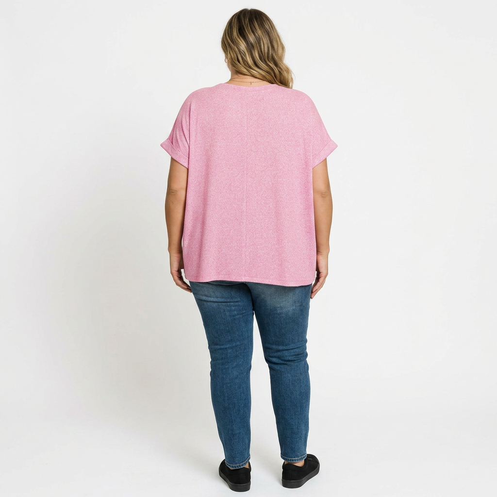 Person wearing a pink t-shirt and blue jeans on a white background