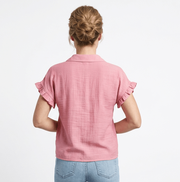 Person wearing a pink blouse and blue jeans on a white background
