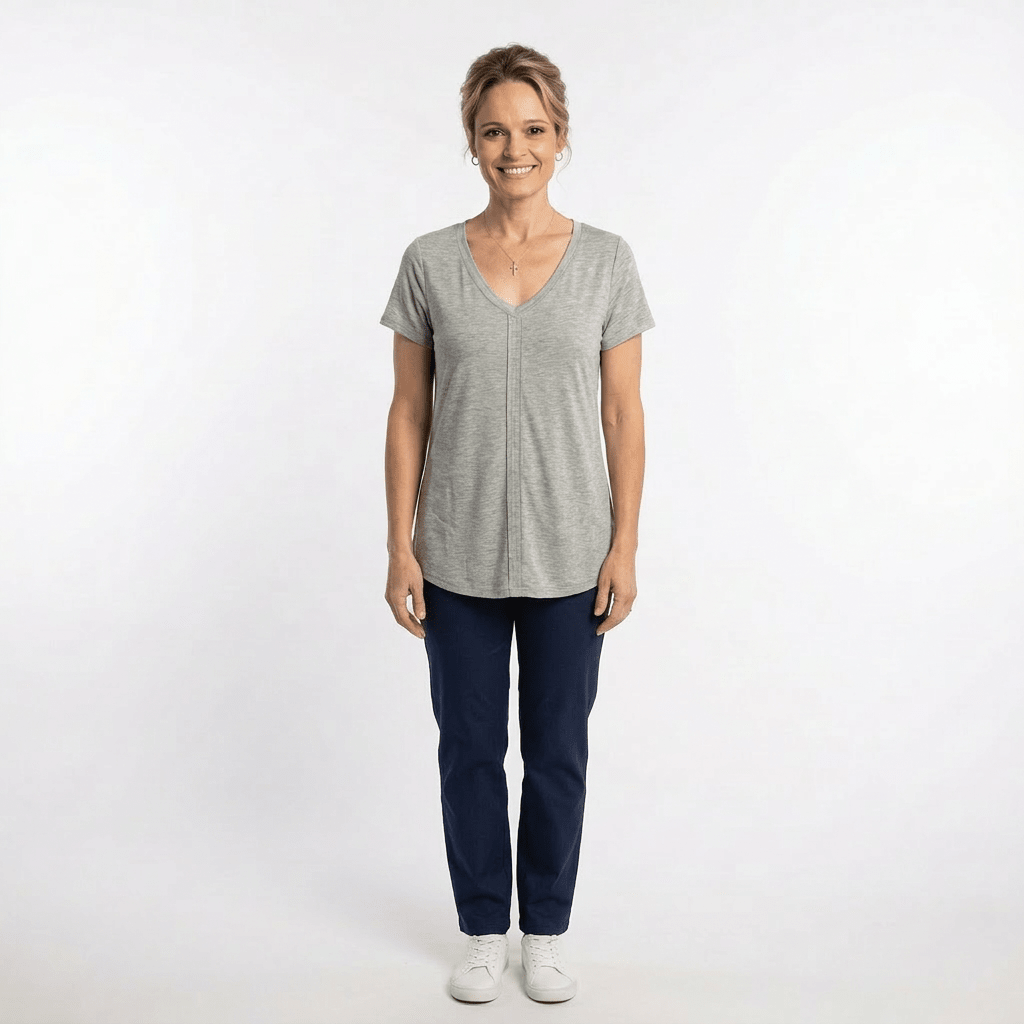 Woman wearing a gray t-shirt and blue pants on a white background