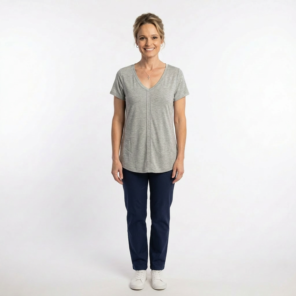 Woman wearing a gray t-shirt and blue pants on a white background