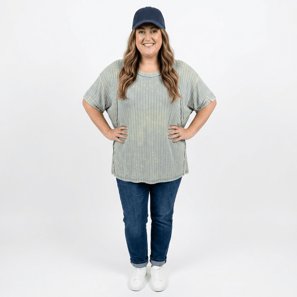 woman wearing baseball cap and ribbed long t-shirt with jeans