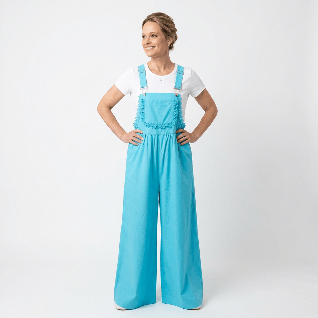 Woman wearing bright blue overalls and a white shirt on a white background
