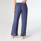 Navy blue pants with lace trim on a white background