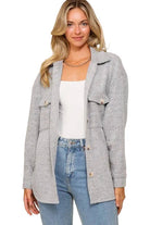 Woman wearing an open heather gray brushed waffle knit shacket with flap pockets over a white tank and jeans