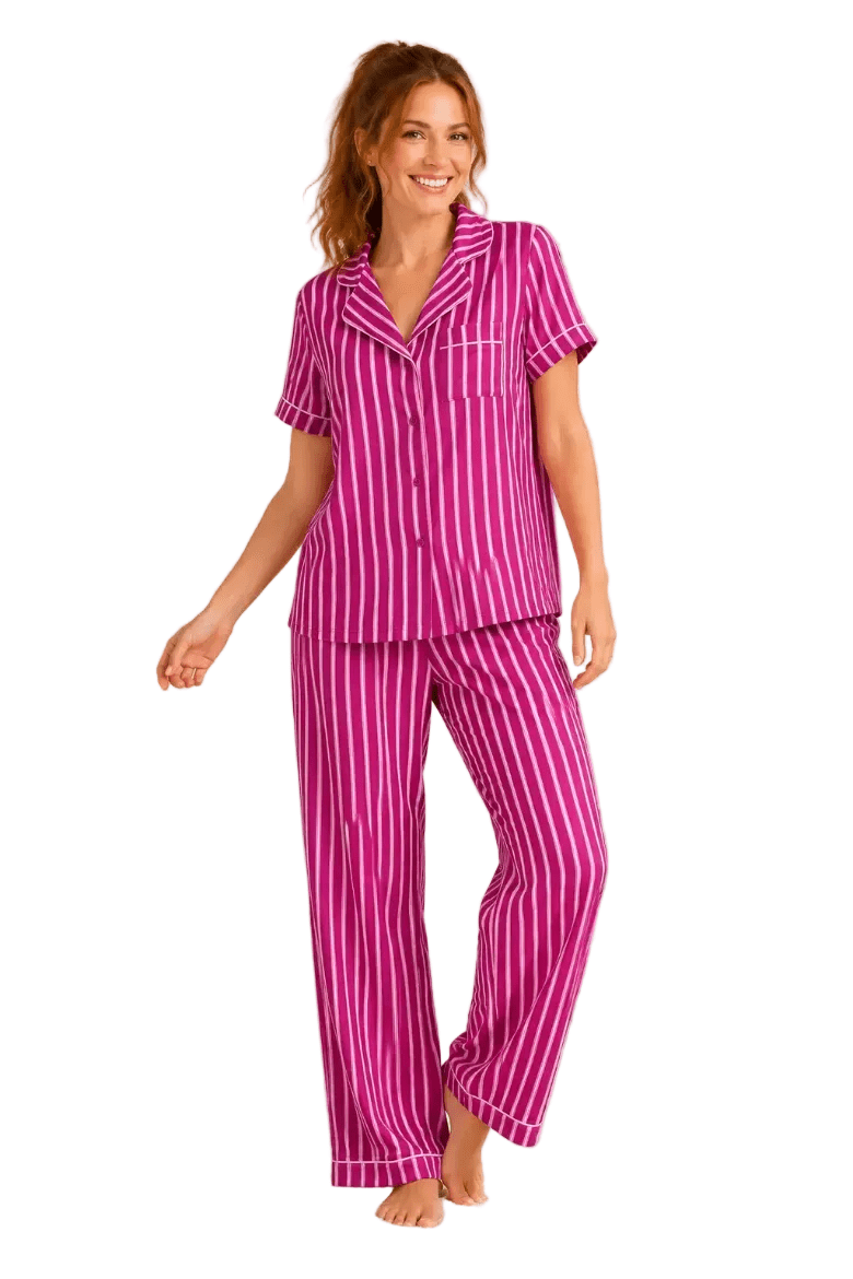 Woman wearing a berry pink and white striped short sleeve button-down pajama set with notch collar, white piping and straight leg pants