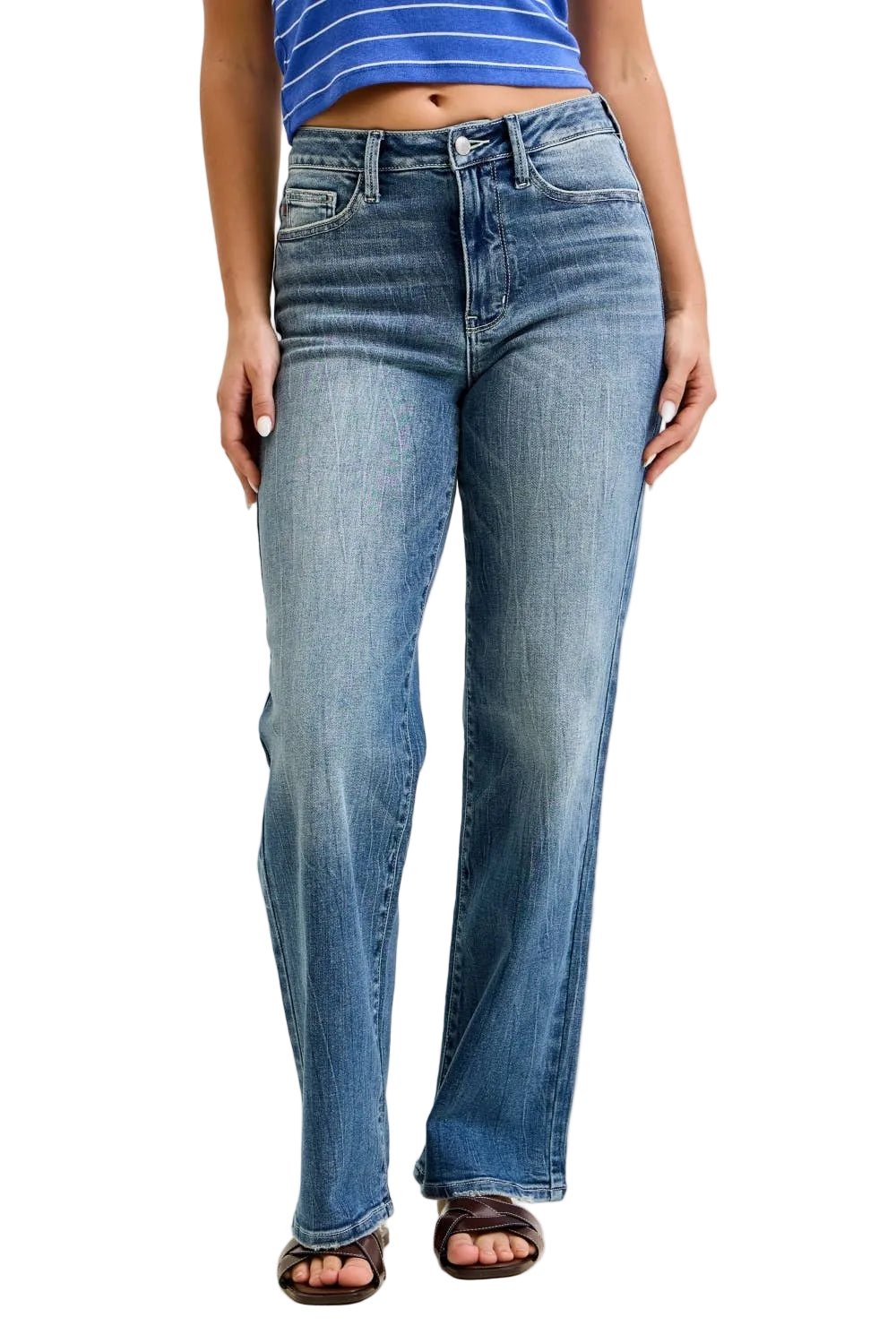 Person wearing blue jeans and a striped shirt on a plain background