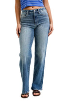 Person wearing blue jeans and a striped shirt on a plain background