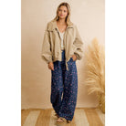 Navy floral wide leg pants styled with a white top and cream sherpa jacket