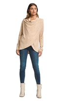 Woman wearing the 2-in-1 hacci cardigan buttoned as a cowl neck sweater with skinny jeans and ankle boots