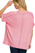 Back view of the candy pink melange tee showing the center back exposed seam and folded sleeves