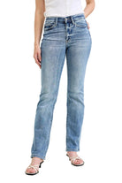 Person wearing light blue jeans on a plain background