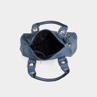 Blue handbag with silver hardware on a light gray background