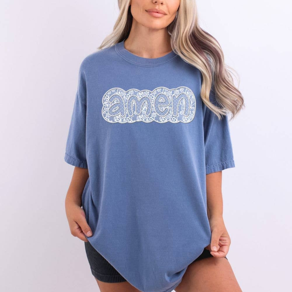 Person wearing a blue t-shirt with 'amen' printed on it against a white background