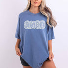 Person wearing a blue t-shirt with 'amen' printed on it against a white background