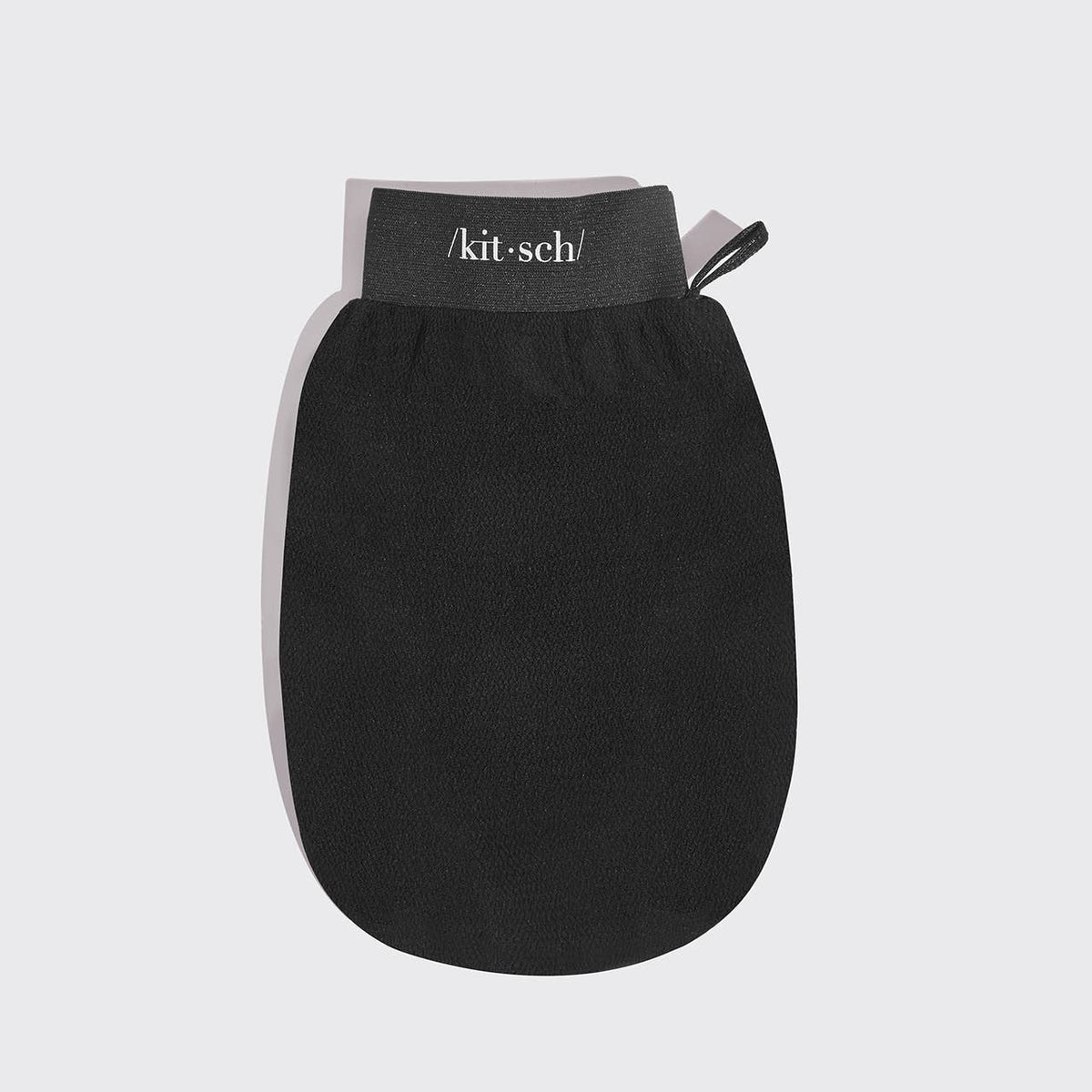 Black exfoliating shower mitt with KITSCH logo and hanging loop on white
