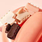 Close-up of Kitsch mini cloud claw clips in blush, terracotta and brown