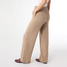 Side view of beige knit wide leg pull on sweater pants showing the relaxed wide leg