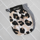 Kitsch leopard exfoliating glove on a gray background