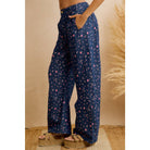 Side view of navy floral wide leg pants with hand in front pocket