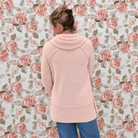 Back view of the smoke pink cowl neck top showing the raglan sleeves and banded tunic hem