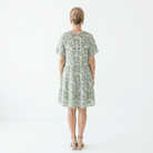 Woman wearing a floral dress on a white background