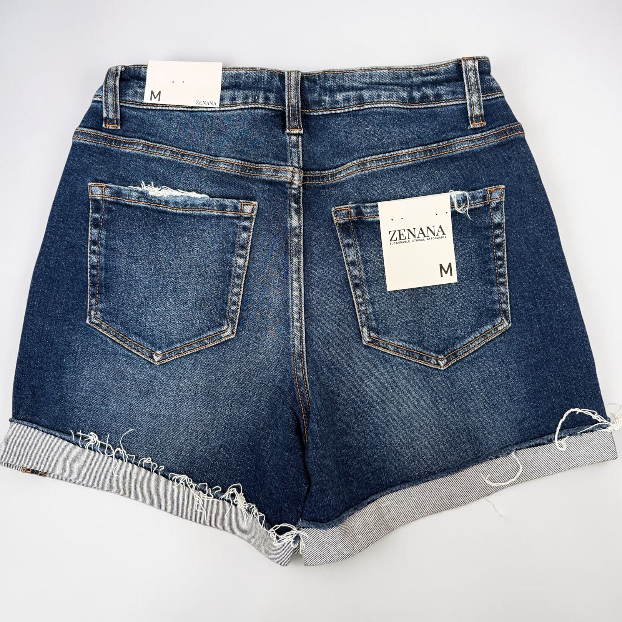 Blue denim shorts with a visible brand label on a white background